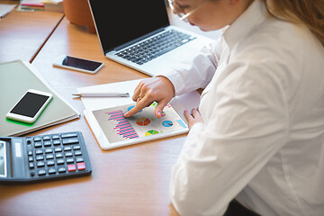 Image showing Caucasian entrepreneur, businesswoman, manager working concentrated in office, close up, focus on hands