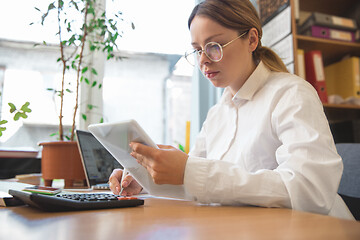 Image showing Caucasian entrepreneur, businesswoman, manager working concentrated in office