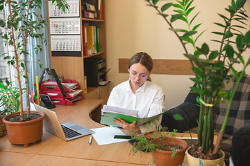 Image showing Caucasian entrepreneur, businesswoman, manager working concentrated in office