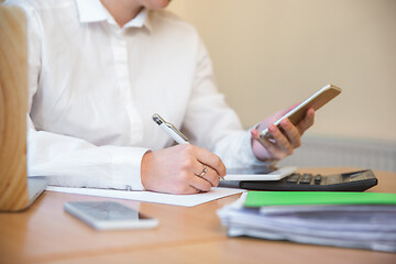 Image showing Caucasian entrepreneur, businesswoman, manager working concentrated in office, close up, focus on hands