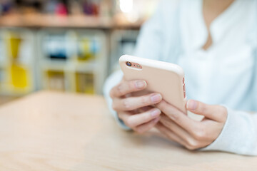 Image showing Woman working on cellphone on table