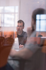 Image showing businessman working using a laptop in startup office