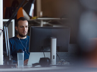 Image showing businessman working using a laptop in startup office