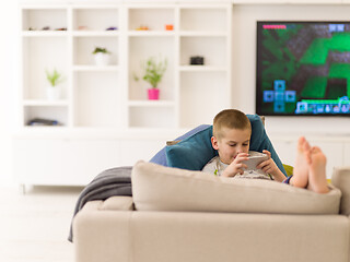 Image showing little boy playing games on smartphone