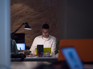 Image showing businessman working using a laptop in startup office