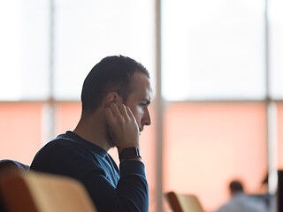 Image showing business man listening music on headphones