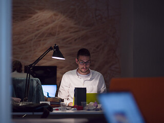 Image showing businessman working using a laptop in startup office