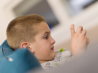 Image showing little boy playing games on smartphone