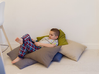 Image showing little boy playing games on tablet computers