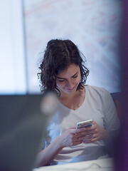 Image showing Businesswoman typing on phone  in office