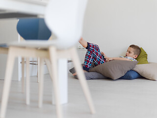 Image showing little boy playing games on tablet computers