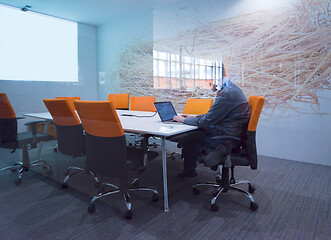 Image showing businessman working using a laptop in startup office