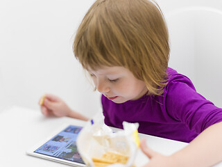 Image showing little girl playing games on tablet computer