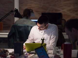 Image showing businessman working using a laptop in startup office