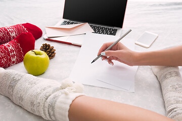 Image showing caucasian couple at home using internet technology LLaptop and phone for people sitting on the floor