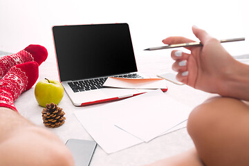 Image showing caucasian couple at home using internet technology LLaptop and phone for people sitting on the floor