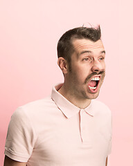 Image showing The man screaming with open mouth isolated on pink background, concept face emotion