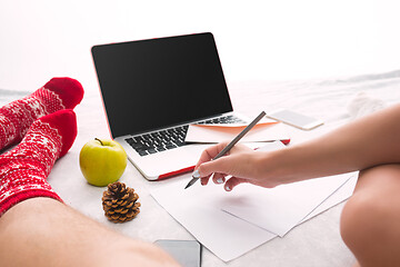 Image showing caucasian couple at home using internet technology LLaptop and phone for people sitting on the floor