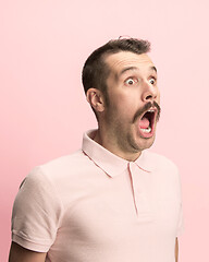 Image showing The man screaming with open mouth isolated on pink background, concept face emotion