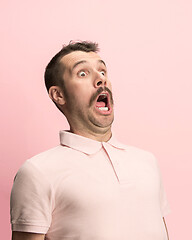 Image showing The man screaming with open mouth isolated on pink background, concept face emotion