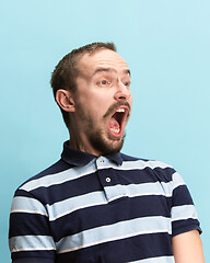 Image showing The man screaming with open mouth isolated on blue background, concept face emotion