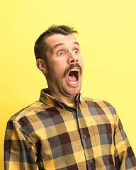 Image showing The man screaming with open mouth isolated on yellow background, concept face emotion