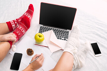 Image showing caucasian couple at home using internet technology LLaptop and phone for people sitting on the floor