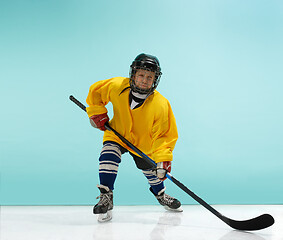 Image showing A hockey player with equipment over a blue background