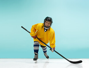 Image showing A hockey player with equipment over a blue background