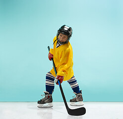 Image showing A hockey player with equipment over a blue background