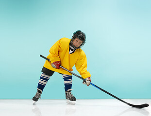 Image showing A hockey player with equipment over a blue background