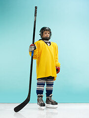 Image showing A hockey player with equipment over a blue background