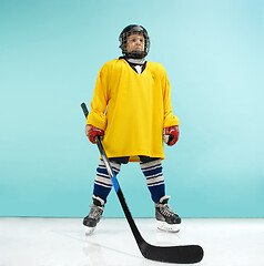 Image showing A hockey player with equipment over a blue background