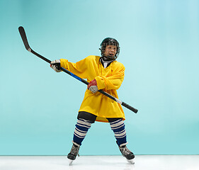 Image showing A hockey player with equipment over a blue background