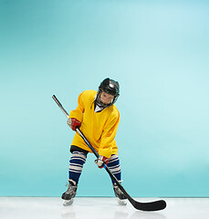 Image showing A hockey player with equipment over a blue background