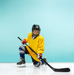 Image showing A hockey player with equipment over a blue background