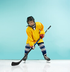 Image showing A hockey player with equipment over a blue background