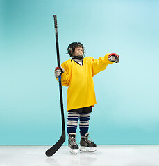 Image showing A hockey player with equipment over a blue background