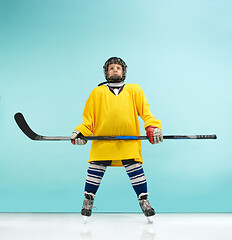 Image showing A hockey player with equipment over a blue background