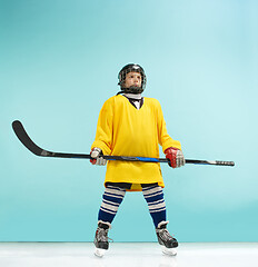 Image showing A hockey player with equipment over a blue background