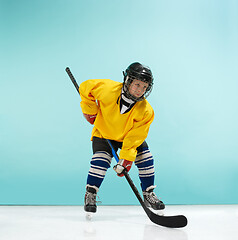 Image showing A hockey player with equipment over a blue background