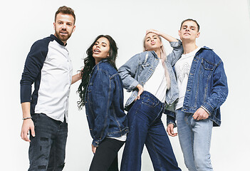 Image showing Group of smiling friends in fashionable jeans