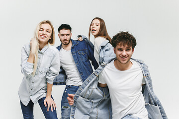 Image showing Group of smiling friends in fashionable jeans