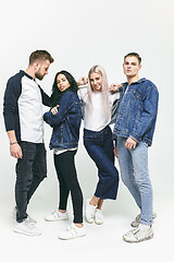 Image showing Group of smiling friends in fashionable jeans