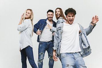 Image showing Group of smiling friends in fashionable jeans