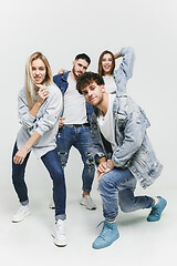 Image showing Group of smiling friends in fashionable jeans