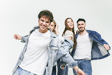 Image showing Group of smiling friends in fashionable jeans