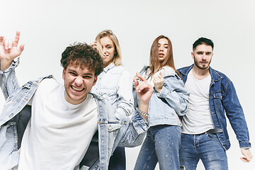 Image showing Group of smiling friends in fashionable jeans