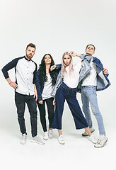 Image showing Group of smiling friends in fashionable jeans