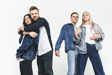 Image showing Group of smiling friends in fashionable jeans